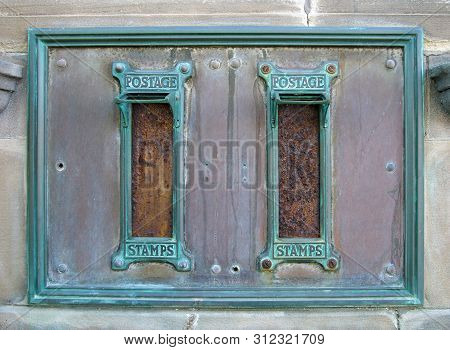 Old British Postal Mail Boxes With Rusted Letter Slots And Ornate Green Copper Frames With The Words