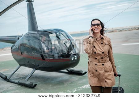 Business woman near private a helicopter
