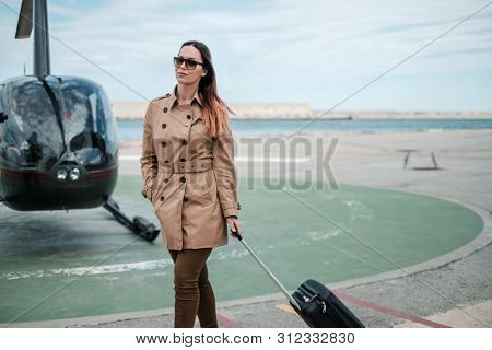 Business woman near private a helicopter