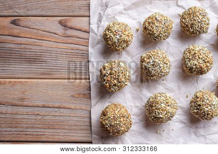 Top View Of Low-fat Energy Balls With Nuts On Paper. Left Copy Space