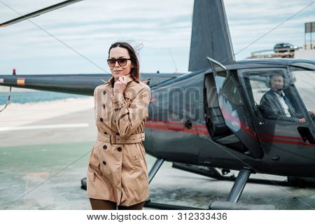 Business woman near private a helicopter