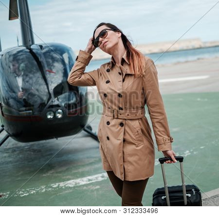 Business woman near private a helicopter