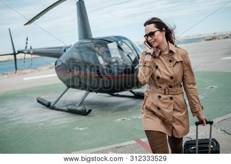 Business woman near private a helicopter