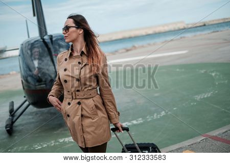 Business woman near private a helicopter