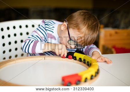 Little Ginger Boy With Glasses With Syndrome Dawn Playing