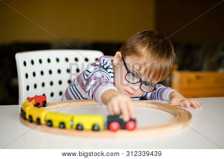 Little Ginger Boy With Glasses With Syndrome Dawn Playing