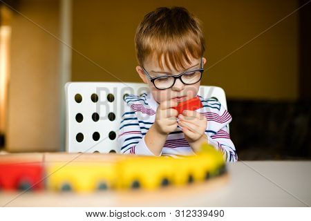 Little Ginger Boy With Glasses With Syndrome Dawn Playing