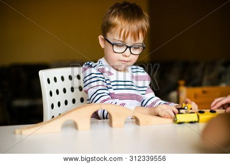Little Ginger Boy With Glasses With Syndrome Dawn Playing