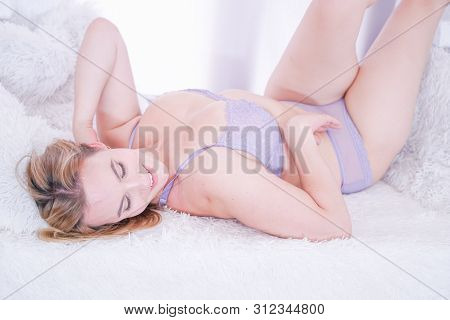Pretty Cute Plus Size Woman Wearing Sexy Lingerie And Posing On The Windowsill