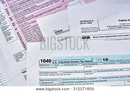 Tax Form 1040, Schedule D, 1040a On A Tax Documents Background