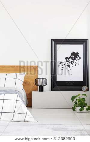 Elegant Bedroom With White Wall And Chequered Bedding