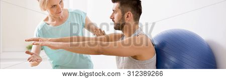 Panoramic View Of Handsome Young Man During Kinesiotherapy After Car Accident