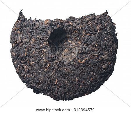 Round Disc Of Traditional Chinese Shu Puer Or Puerh Tea Isolated On A White Background