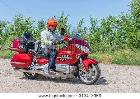 Eger, Hungary - July 04, 2019: Motor Biker At Red Honda Goldwing Making A Drive Through Hungary Betw