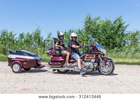 Eger, Hungary - July 04, 2019: Motor Bikers At Purple Honda Goldwing With Trailer Making A Drive Thr