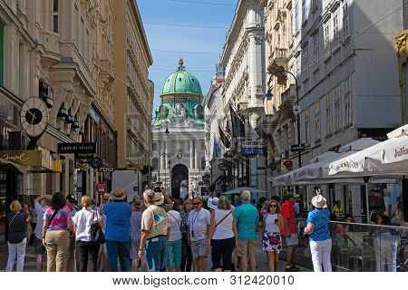 Vienna, Austria - July 20, 2019: Large Group Of Tourists Like To Visit The Pedestrian Zone Kohlmarkt