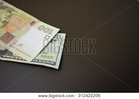 Paper Bills In The Size Of Usd 20 $ Twenty American Dollars And Uah 100 One Hundred Ukrainian Hryvni
