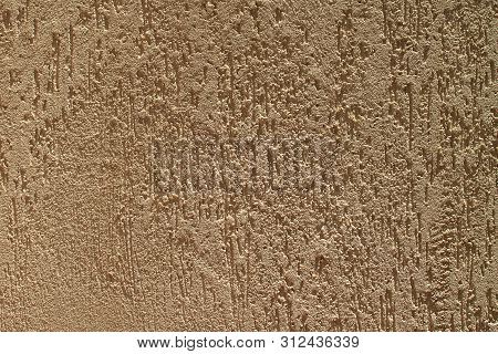 Texture Of A Rough Beige Concrete House Wall In Sunlight