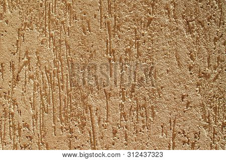 Texture Of A Rough Beige Concrete House Wall In Sunlight