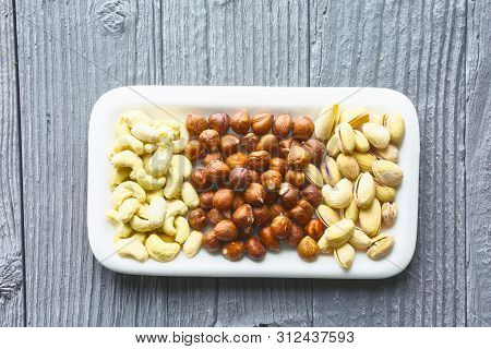 Mixed Nuts On A Wooden Table, Top View