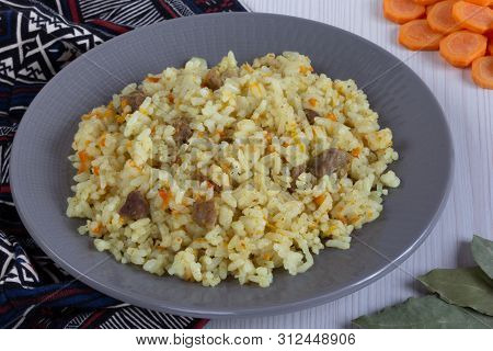 Rice With Small Pieces Of Meat And Carrot On Grey Plate