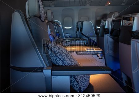 Armchairs In The Business Class On The Plane. Lamps, Pillows, Closed Windows. Air Astana Airline Fli