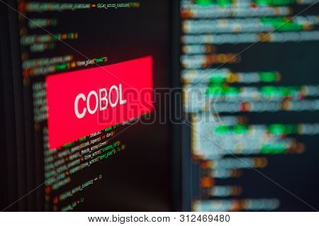 Programming Language, Cobol Inscription On The Background Of Computer Code. Modern Digital Technolog