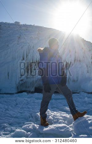 Man Walking On  Ice In Frozen Lake At Lake Bikal, Russia
