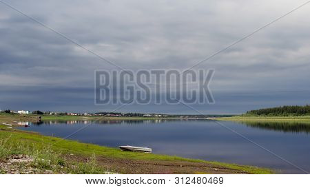 The Boat Is On The Shore Of The Stone Turning Wild North Of The River Vilyui Bright In The Evening O