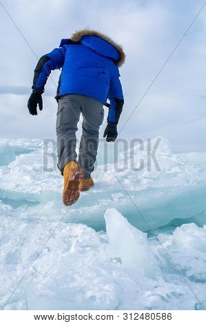 Man Walking On  Ice In Frozen Lake At Lake Bikal, Russia