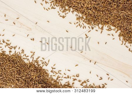 Lot Of Whole Dry Caraway Fruits Copyspace In The Middle Flatlay On White Wood