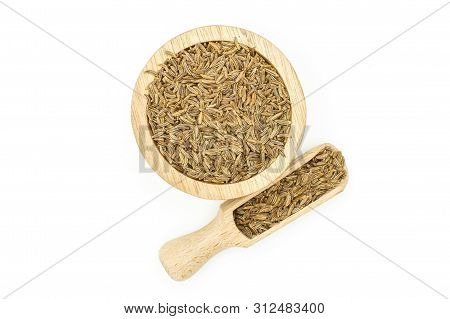 Lot Of Whole Dry Caraway Fruits Closeup In A Wooden Bowl With Wooden Scoop Flatlay Isolated On White