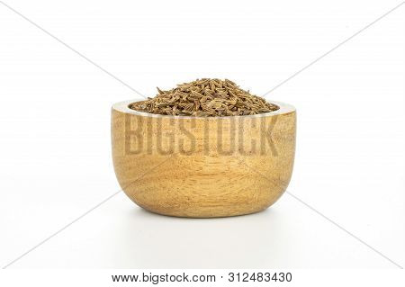 Lot Of Whole Dry Caraway Fruits In A Wooden Bowl Isolated On White Background