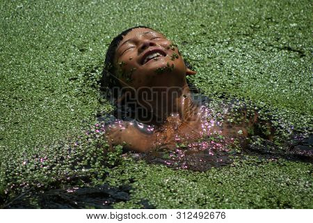 A Small Kids Swimming On Algae Pond During Summer Time At Kritipur, Nepal On June 16, 2019.