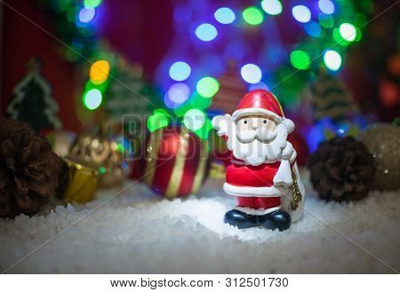 Santa Claus Doll With Bokeh Background And Happy New Year Concept