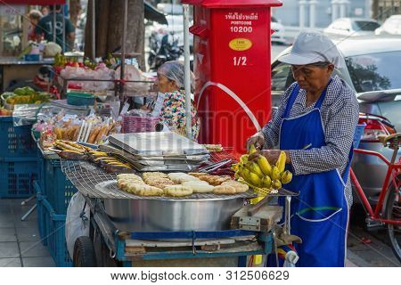 Bangkok, Thailand - January 02, 2019: An Elderly Woman Sells Fried Bannans. Bangkok Street Food