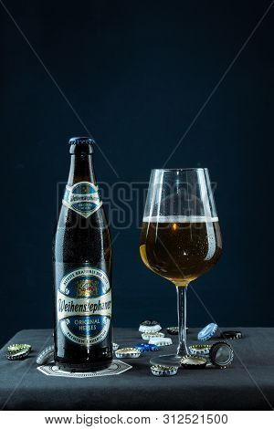Khabarovsk, Russia - Jul 21, 2018: Beer Bottle Weihenstephan And A Glass Of Beer On Table On Blue Ba