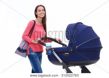 Full length portrait of a mother with a stroller, isolated on white background. Young mom
