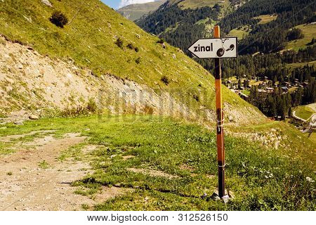 Direction Sign Towards Zinal On Alpine Mountain Trail For Push Scooters Going Downhill