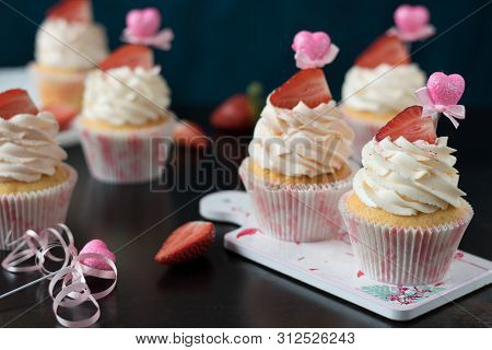 Vanilla Cupcakes Decorated With A Hat Of Cream, Fresh Strawberries And Topper Heart.