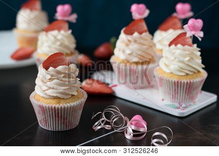 Vanilla Cupcakes With Fresh Strawberries On A Dark Background