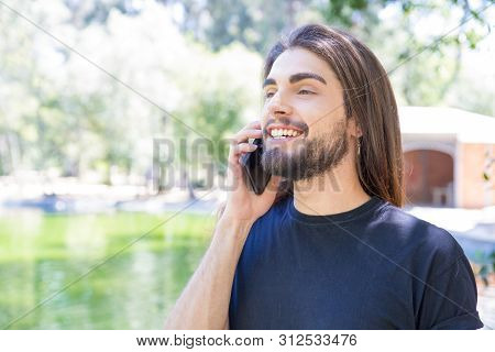Happy Bearded Man With Piercing In Nose Talking On Smartphone. Closeup Shot Of Smiling Young Man Tal