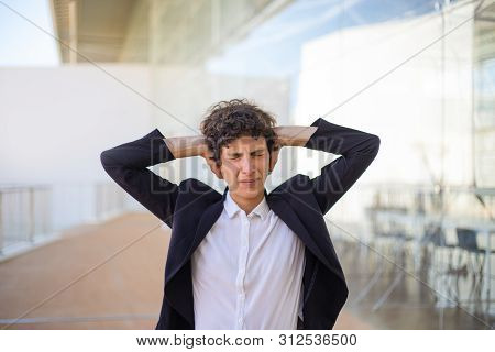Stressed Businesswoman Closing Ears. Unhappy Middle Aged Businesswoman In Formal Wear Standing With 