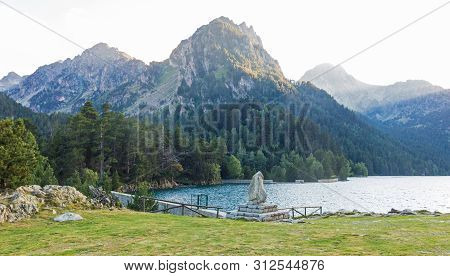Pond Of Sant Maurici, In The Aiguestortes And Sant Maurici National Park. The Peak Amitges On Backgr