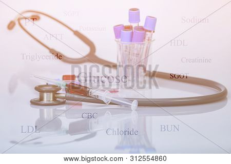 Stethoscope, Blood In Syringe And Blood Sampling Tube In Concept Of Health Check Up By Blood Diagnos