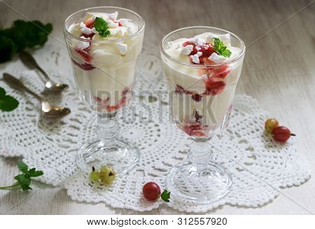 Eton Mess, Traditional English Dessert With Gooseberry, Whipped Cream And Meringue On A Light Backgr