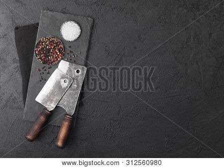 Vintage Meat Knife Hatchets With Stone Chopping Board And Black Table Background. Butcher Utensils. 