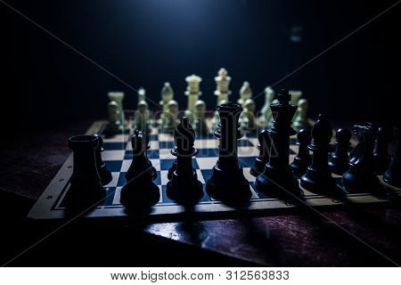 Chess Board Game Concept Of Business Ideas And Competition. Chess Figures On A Dark Background With