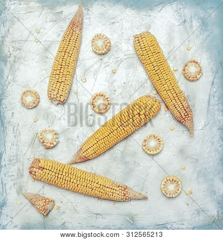 Shucked And Cleaned Sweet Corn On Bright Blue Background. Sweet Corn Cut On Desk.