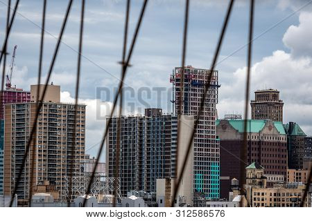 New York, Usa - June 21, 2019:  Manhattan Through The Brooklyn Bridge Metal Ropes.